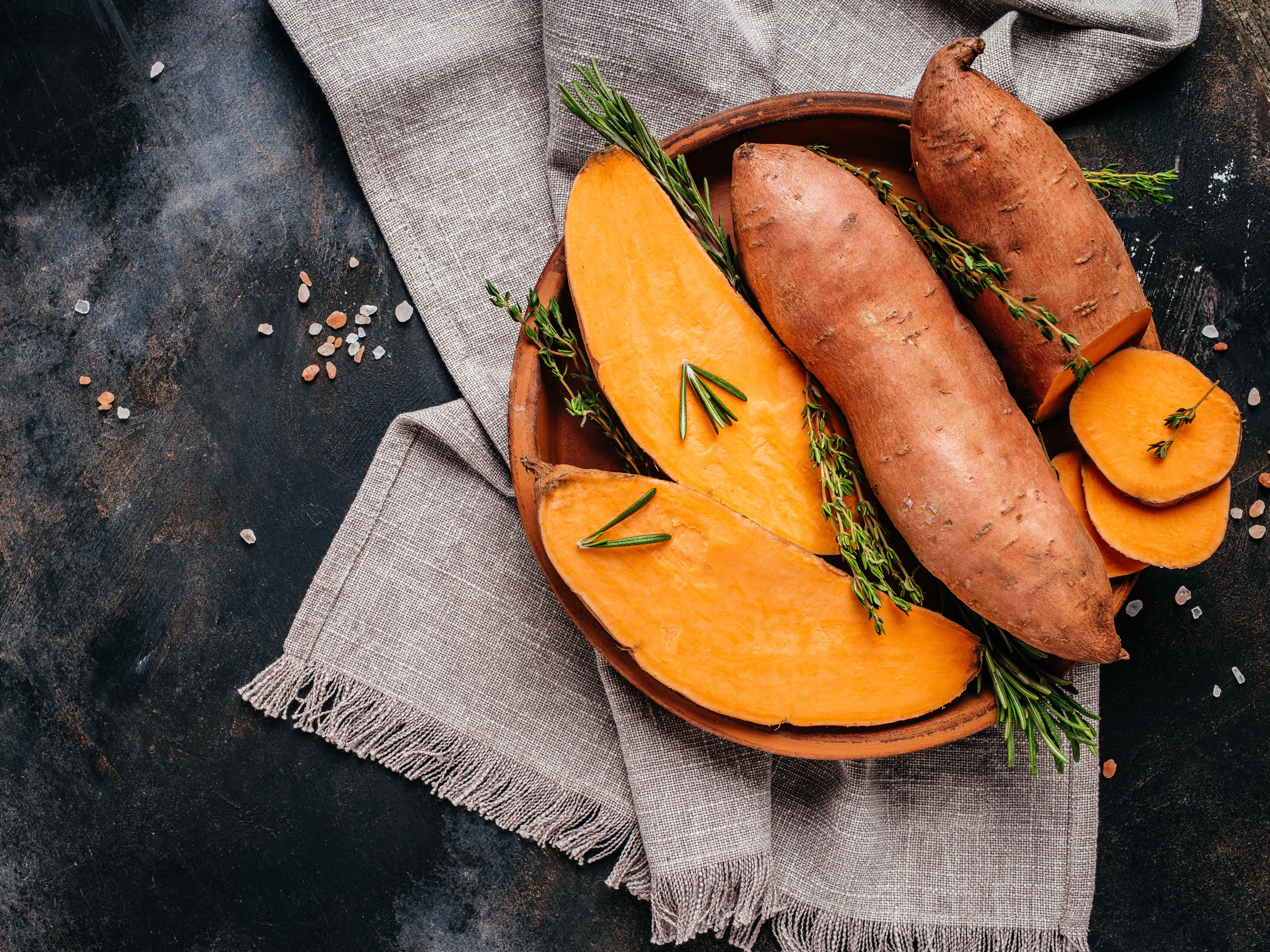 Organic orange sweet potato. Raw sweet potatoes or batatas. vegan food ingredient. banner, menu, recipe place for text, top view.